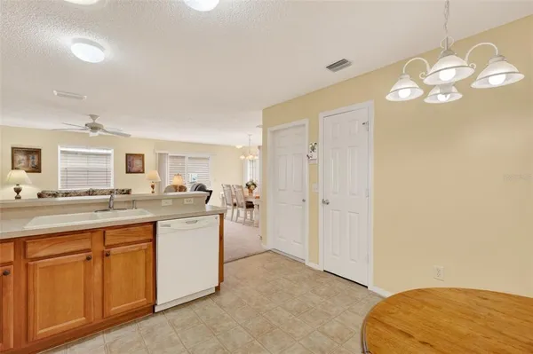 a living room with a sink cabinets and wooden floor