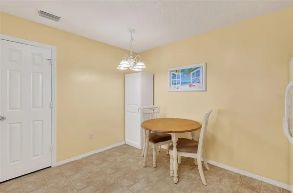 a dining room with furniture and chandelier