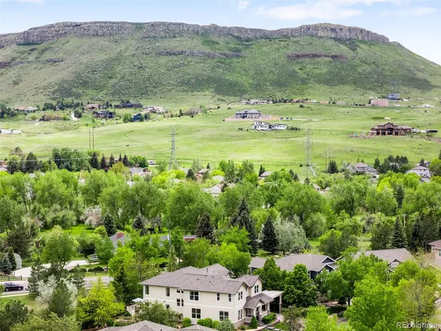 an aerial view of a houses with outdoor space and trees