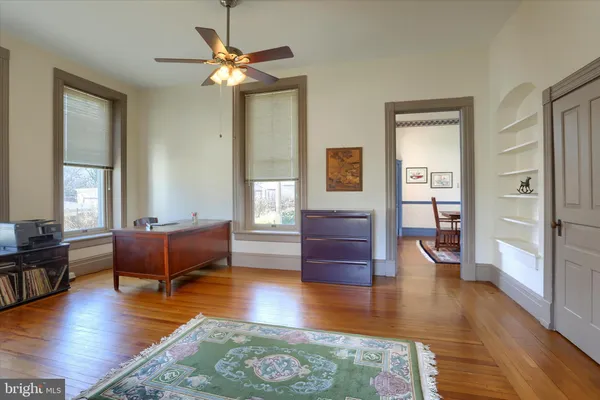 a living room with hardwood floor and windows