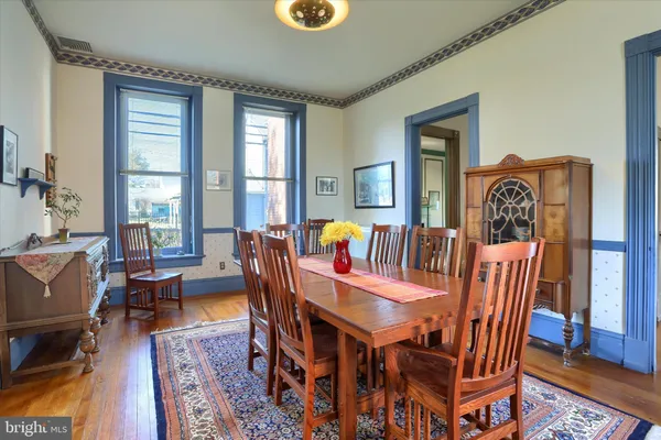 a view of a dining room with furniture window and wooden floor