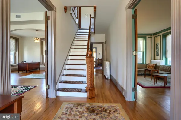 a view of a hallway view with wooden floor and furniture