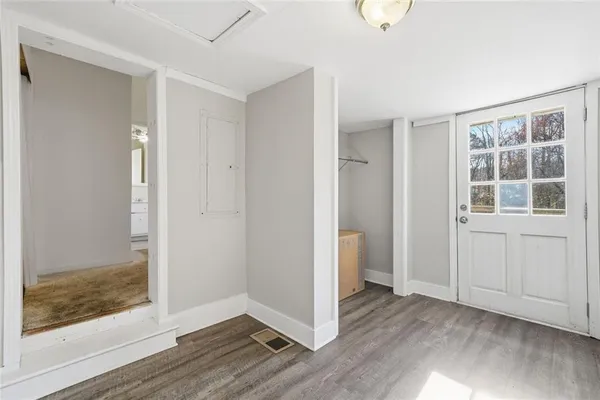 wooden floor in an empty room with a window