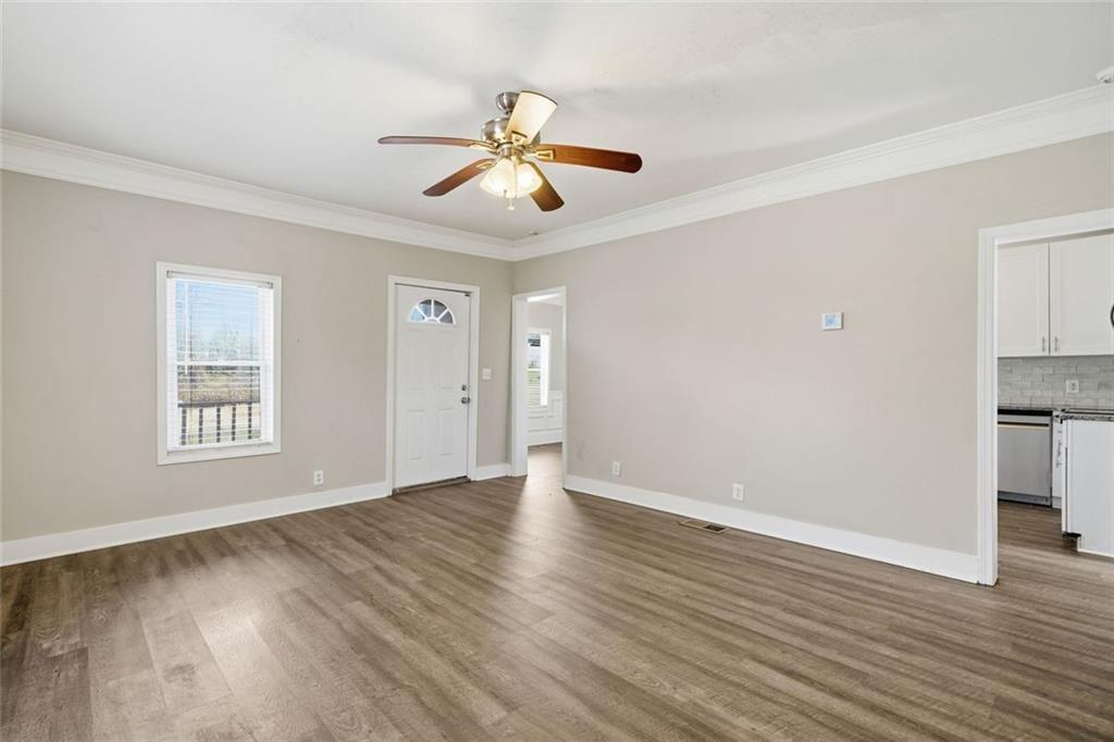 174 Cherokee Avenue Nelson, GA 30151 - Photo 13 of 28 a view of an empty room with wooden floor and a window
