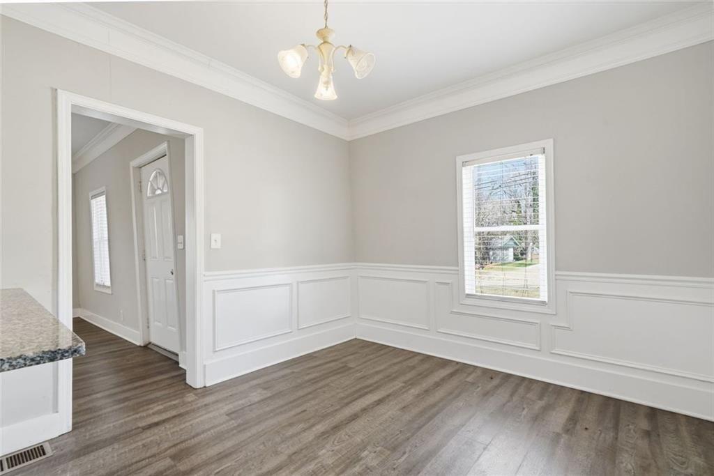 174 Cherokee Avenue Nelson, GA 30151 - Photo 14 of 28 an empty room with wooden floor cabinet and windows