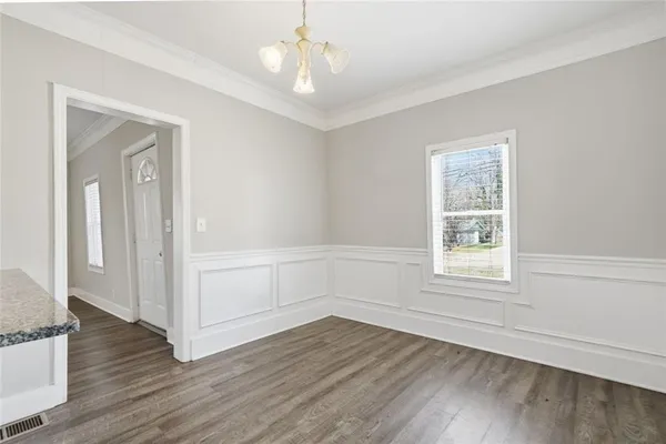 a kitchen with wooden floors and refrigerator