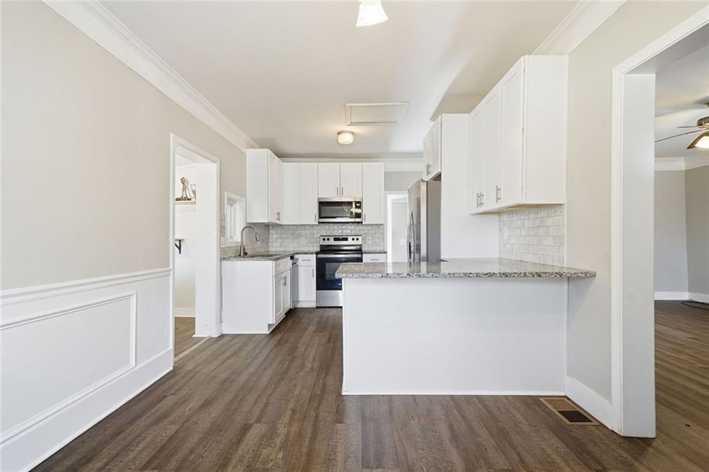 174 Cherokee Avenue Nelson, GA 30151 - Photo 15 of 28 a kitchen with wooden floors and refrigerator