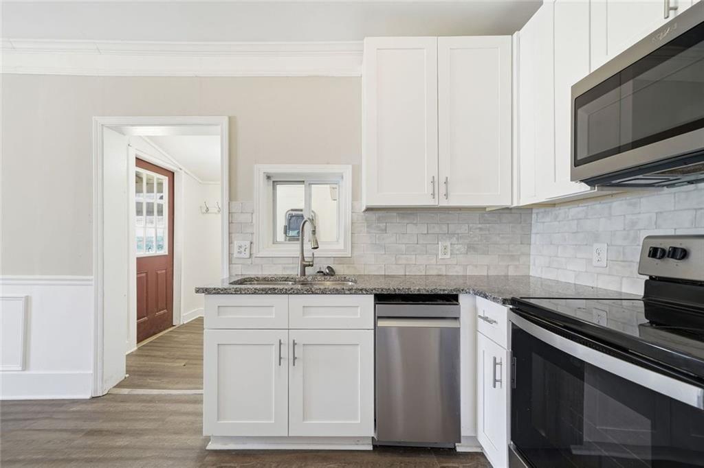 174 Cherokee Avenue Nelson, GA 30151 - Photo 19 of 28 a kitchen with granite countertop a sink and cabinets