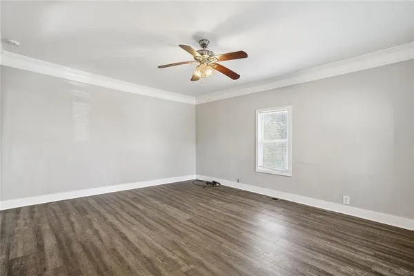 an empty room with windows and closet