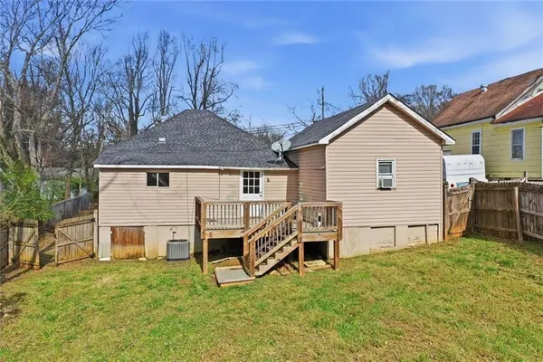 a view of a house with a yard and deck