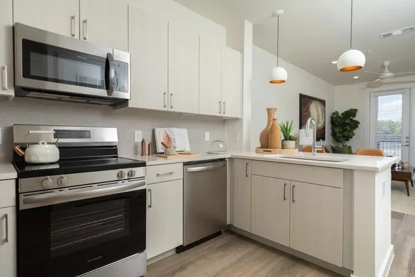 a kitchen with stainless steel appliances granite countertop a stove and a microwave