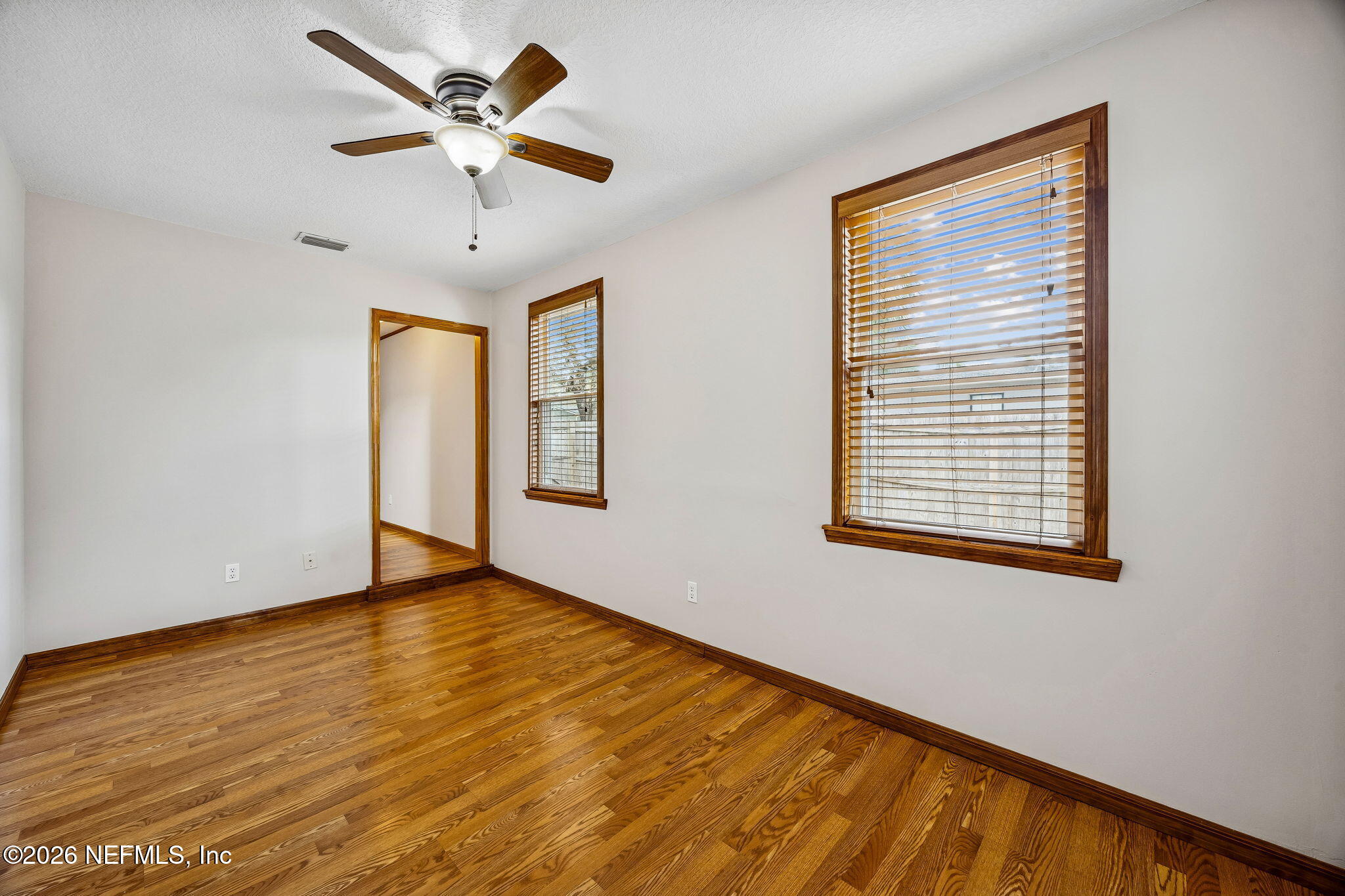 1888 Clemson Road Jacksonville, FL 32217 - Photo 26 of 41 a view of an empty room with window and a ceiling fan