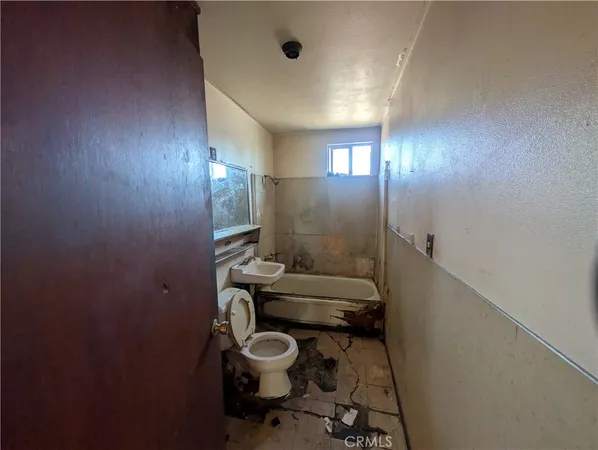 a bathroom with a sink mirror vanity and toilet