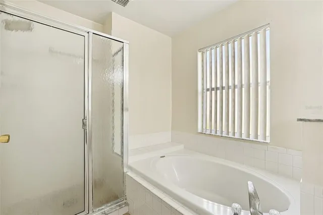 a bathroom with a bathtub and a shower