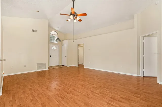 a view of empty room with wooden floor
