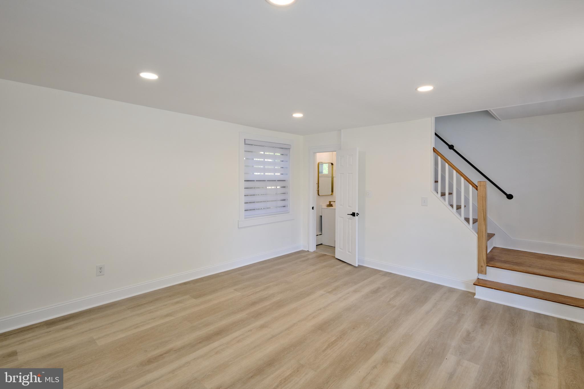 14 West Bridge Street, Unit A New Hope, PA 18938 - Photo 13 of 20 a view of an empty room with wooden floor and stairs