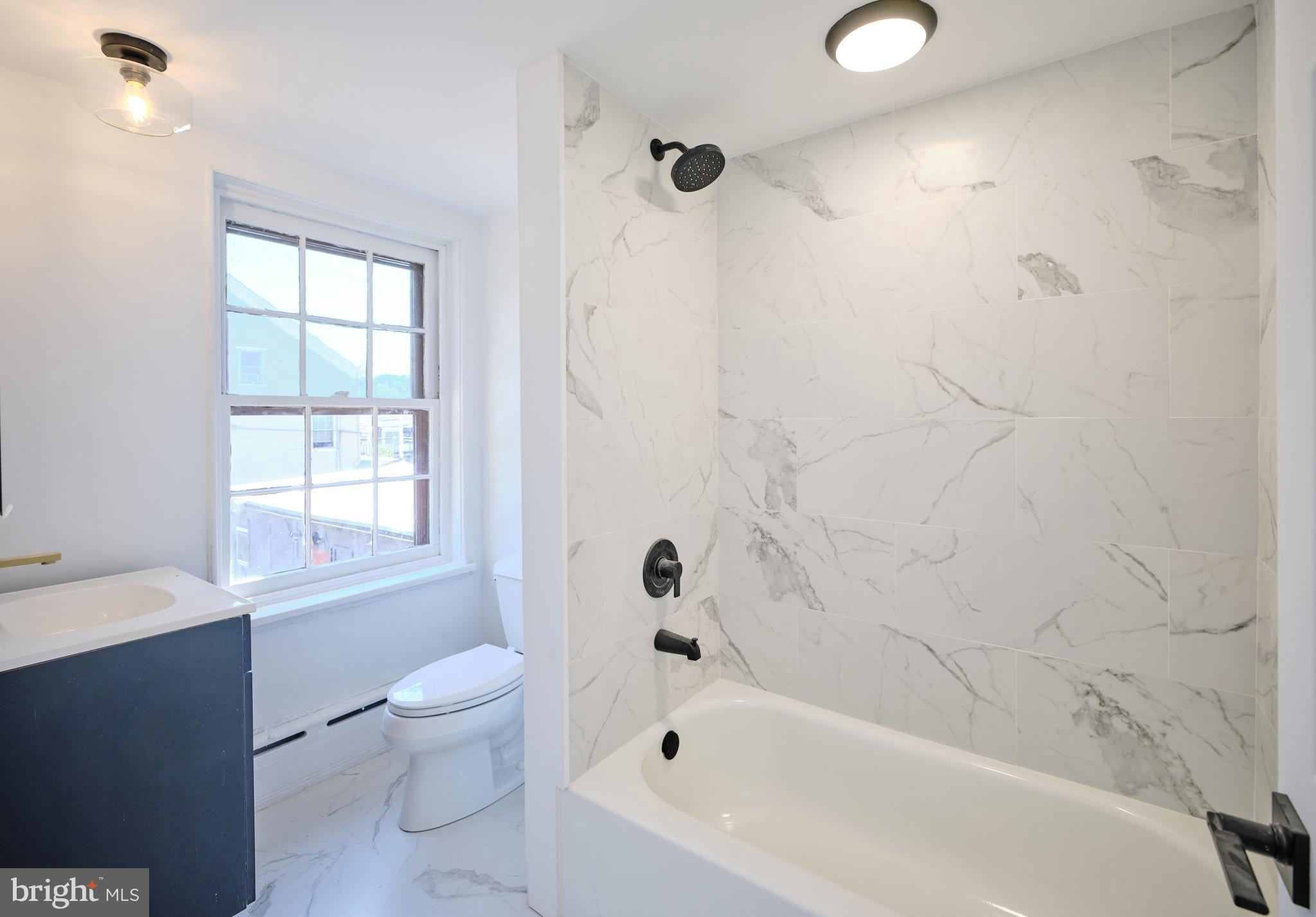 14 West Bridge Street, Unit A New Hope, PA 18938 - Photo 16 of 20 a bathroom with a bathtub sink vanity mirror and toilet