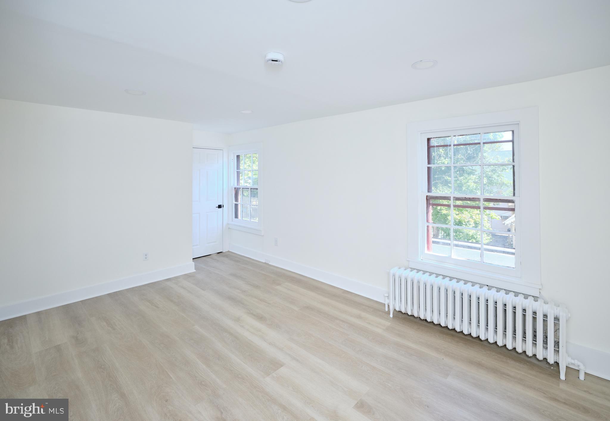 14 West Bridge Street, Unit A New Hope, PA 18938 - Photo 18 of 20 a view of an empty room with wooden floor and a window