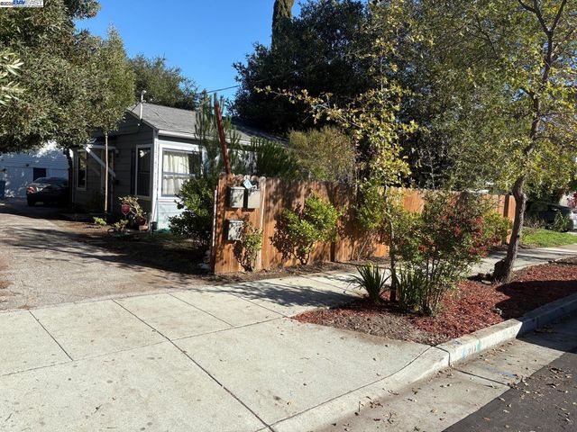 a pathway of a house with a yard