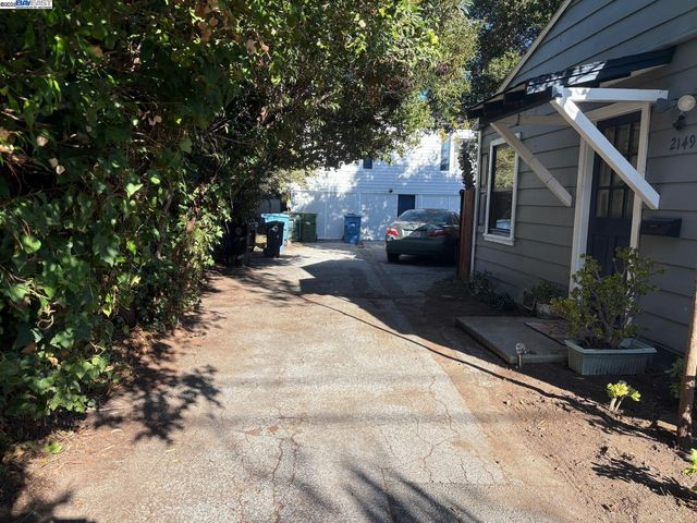 a backyard of a house with plants and tree