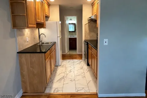 a kitchen with a refrigerator and a sink