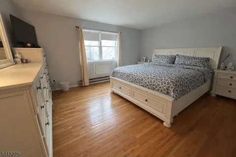 a bedroom with a bed and flat screen tv