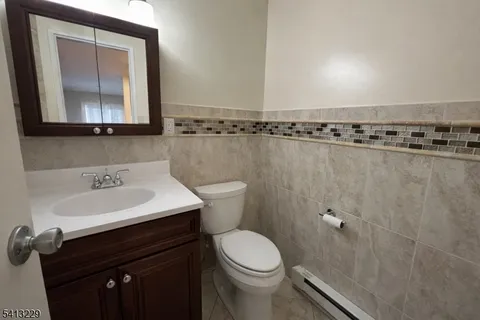 a bathroom with a sink a toilet and mirror