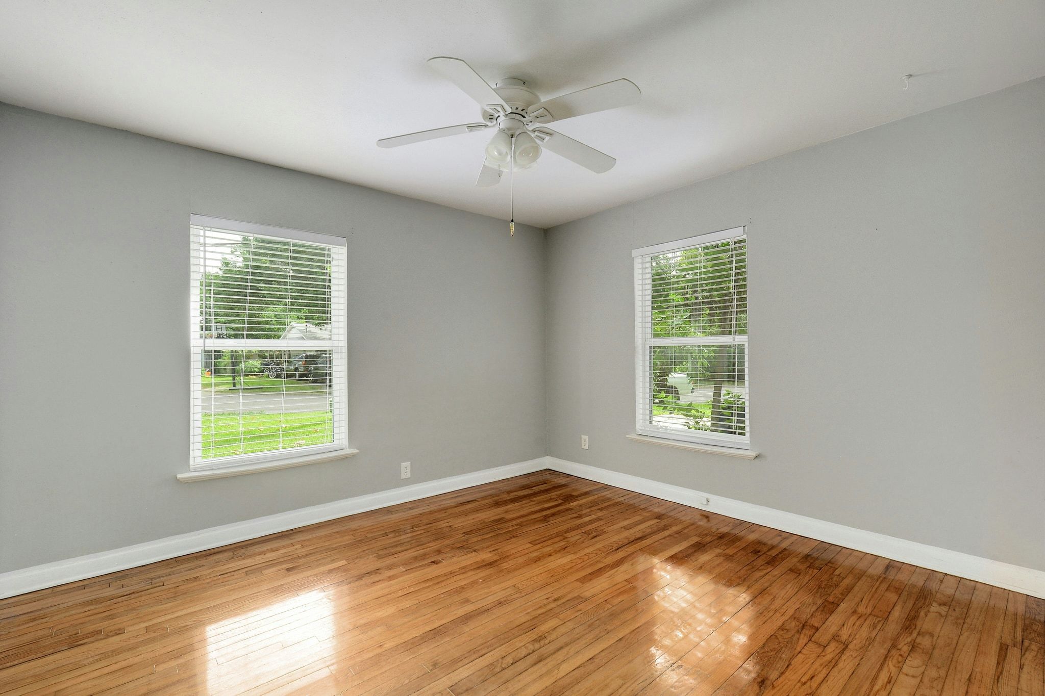 907 East 56th Street Austin, TX 78751 - Photo 11 of 20 an empty room with wooden floor windows and fan