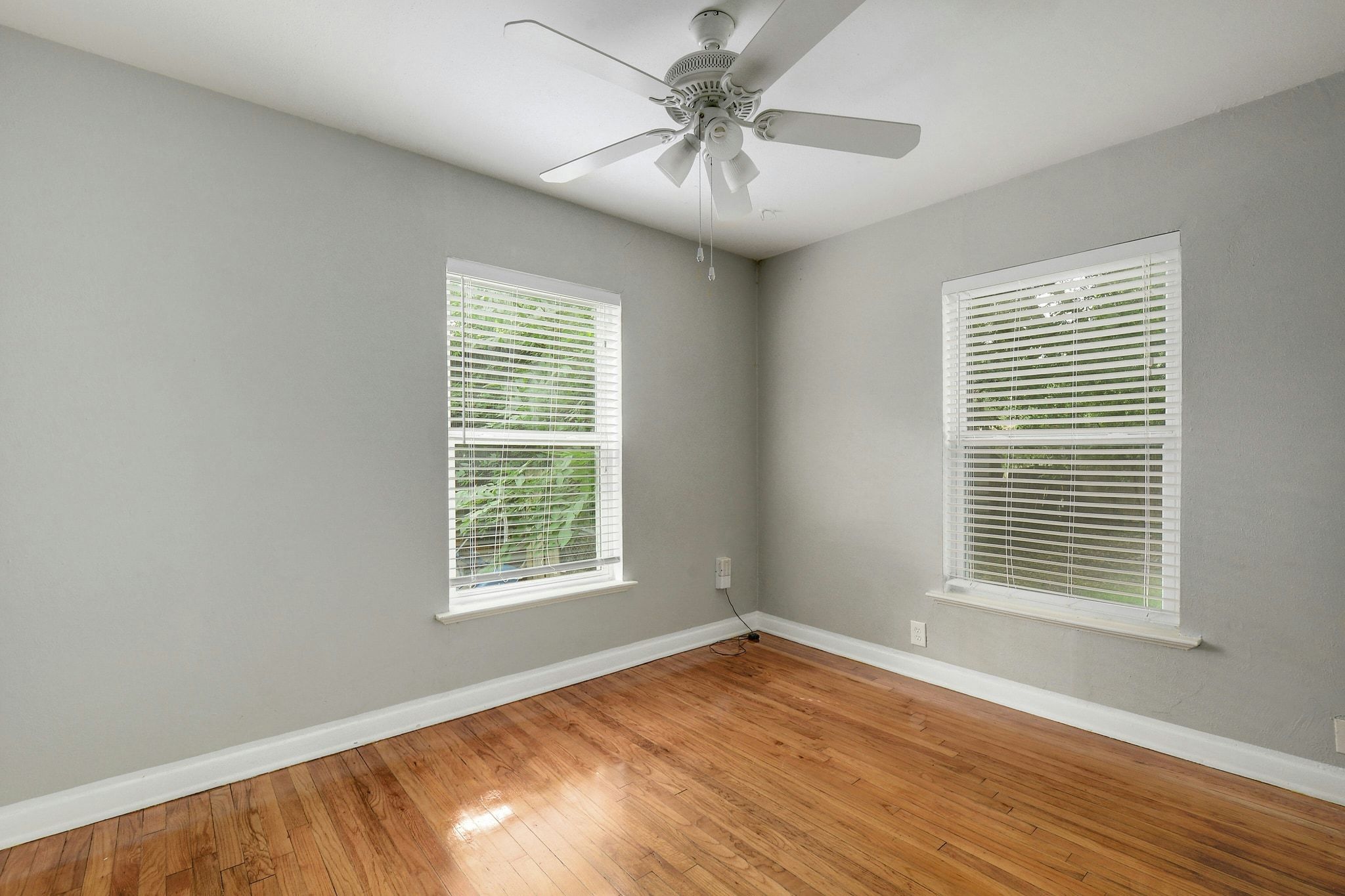 907 East 56th Street Austin, TX 78751 - Photo 13 of 20 a view of an empty room with wooden floor and a window