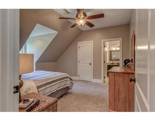 351 East Monomonac Road Rindge, NH 03461 - Photo 20 of 25 a bedroom with a bed and a chandelier