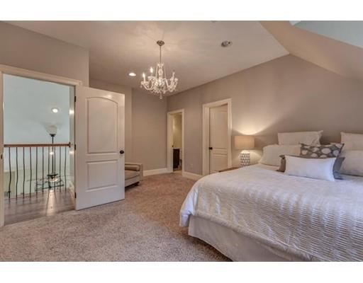 351 East Monomonac Road Rindge, NH 03461 - Photo 22 of 25 a spacious bedroom with a bed and chandelier