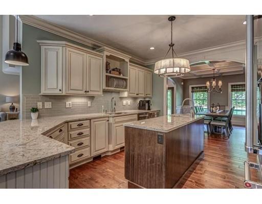351 East Monomonac Road Rindge, NH 03461 - Photo 8 of 25 a kitchen with kitchen island granite countertop a stove a sink dishwasher and white cabinets with wooden floor