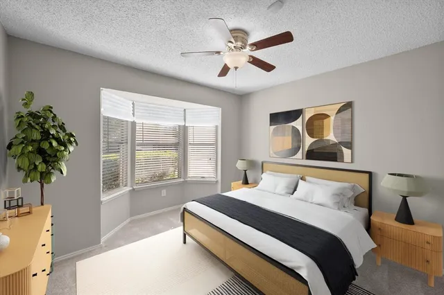 a bedroom with a large bed and a potted plant