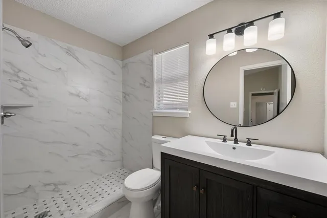 a bathroom with a sink a toilet and a mirror