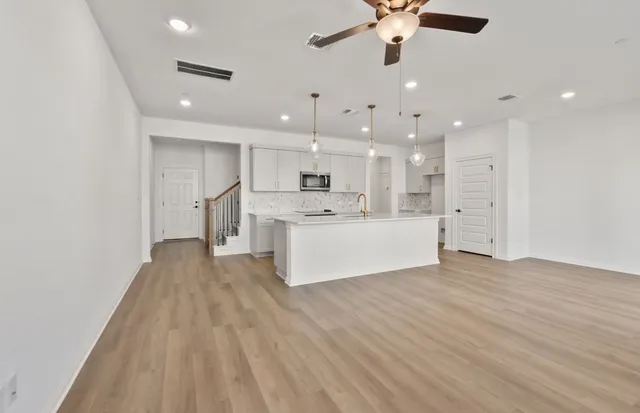 a large kitchen with kitchen island a sink a center island and stainless steel appliances