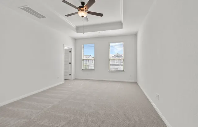 a view of kitchen with cabinets stove and refrigerator
