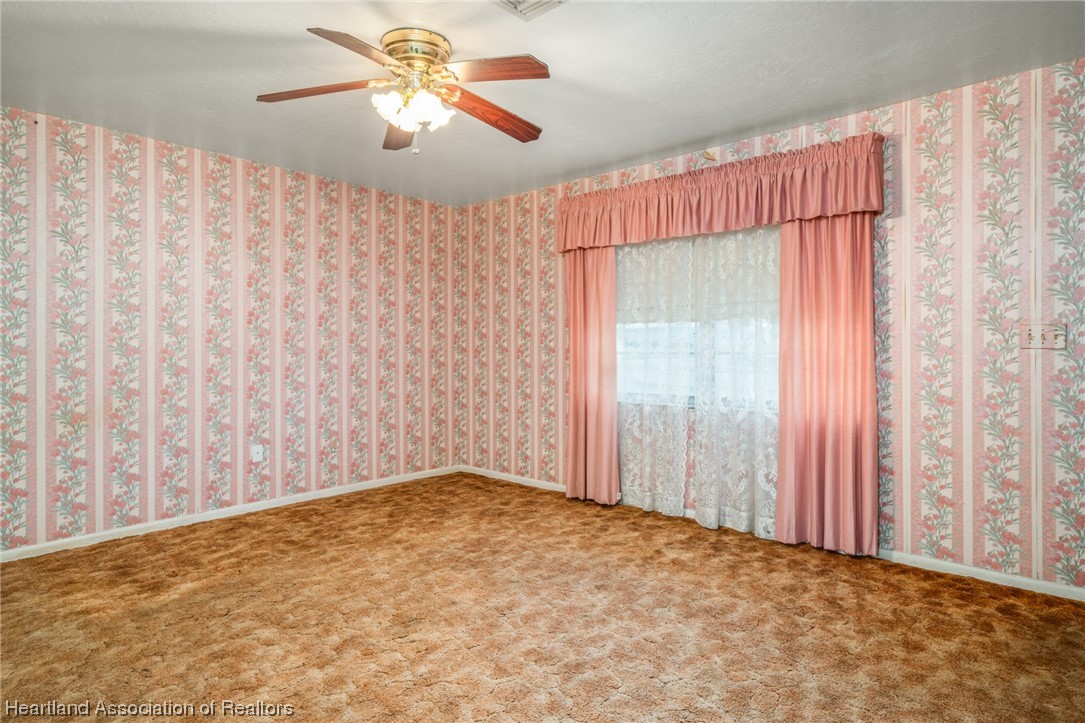 1221 Forest Road Sebring, FL 33872 - Photo 12 of 31 a view of a room with a window and a chandelier