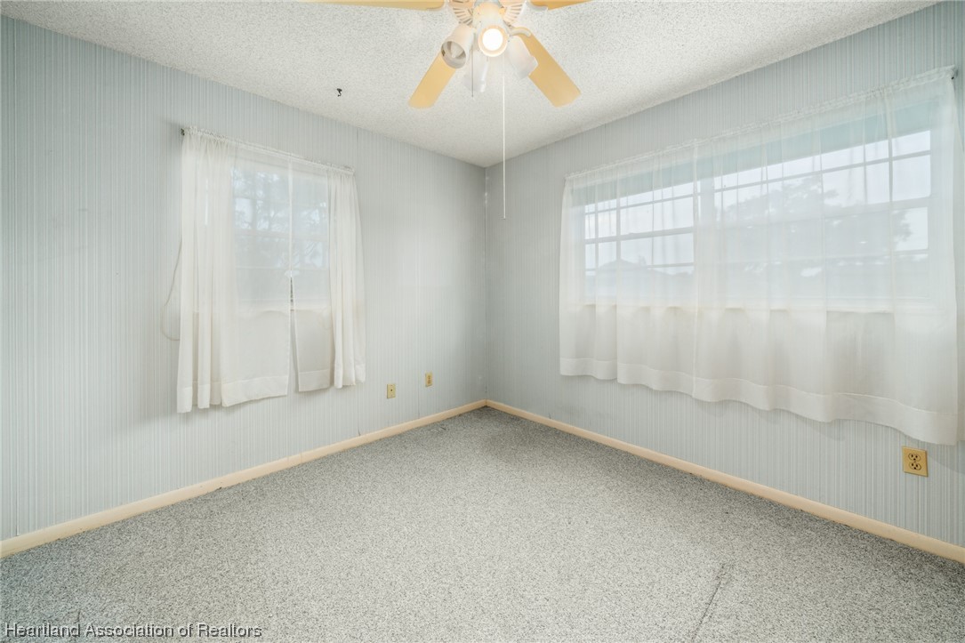 1221 Forest Road Sebring, FL 33872 - Photo 25 of 31 an empty room with a empty space and windows