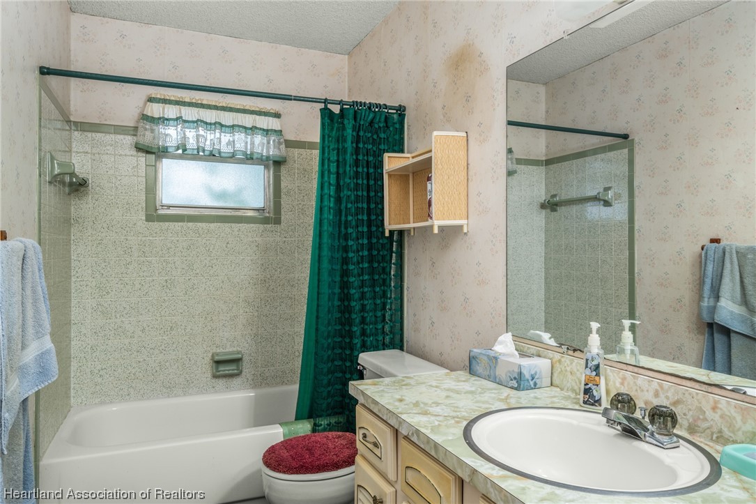 1221 Forest Road Sebring, FL 33872 - Photo 28 of 31 a bathroom with a granite countertop sink toilet and shower