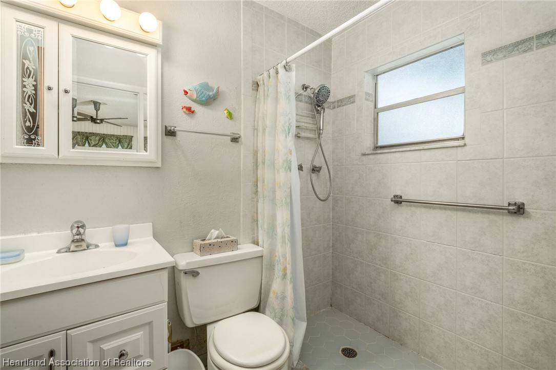 1221 Forest Road Sebring, FL 33872 - Photo 31 of 31 a bathroom with a sink toilet and shower