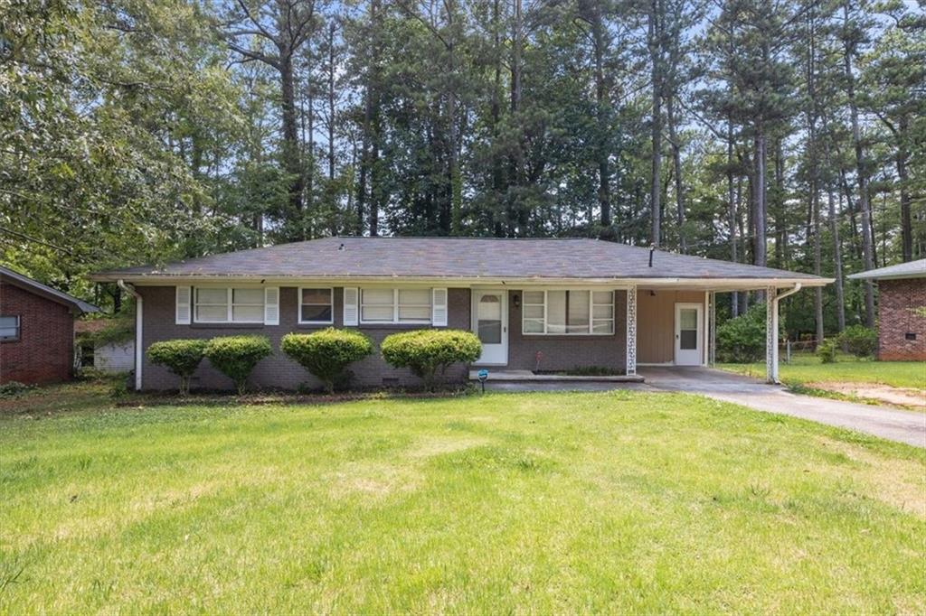 1683 Atherton Drive Decatur, GA 30035 - Photo 1 of 1 a front view of a house with a garden