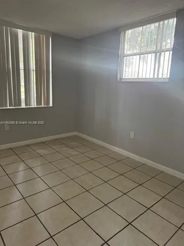 a view of an empty room and a window