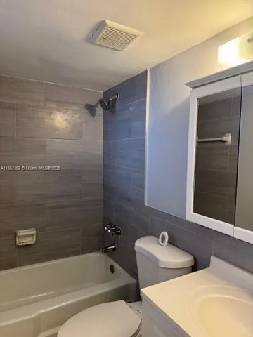 a kitchen with a stove a sink and a window