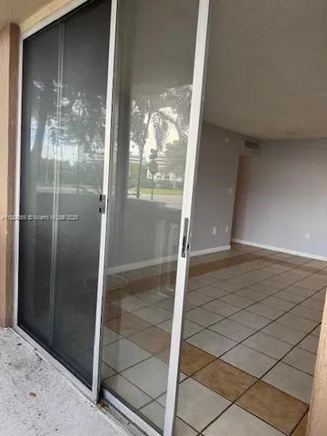 a large white kitchen with a sink a counter top space and appliances