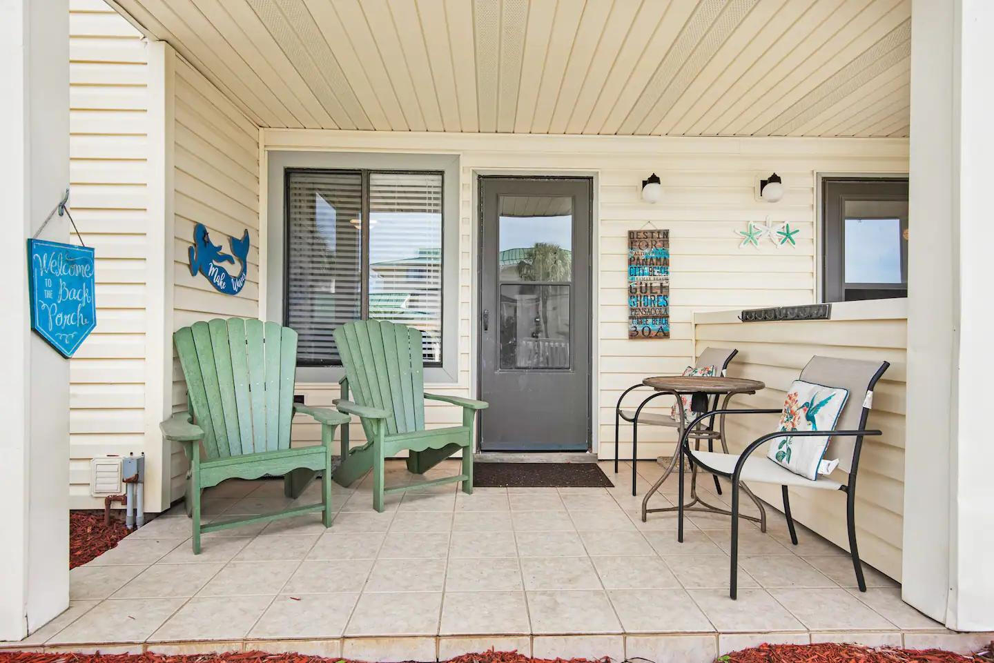 60 Sandprints Drive, Unit E3 Miramar Beach, FL 32550 - Photo 15 of 26 a view of a patio with table and chairs and wooden fence