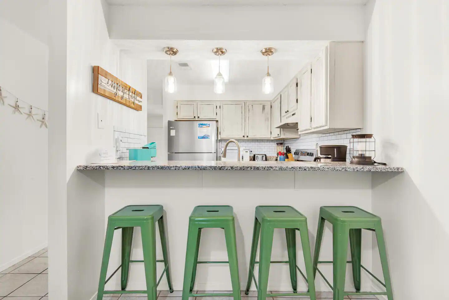 60 Sandprints Drive, Unit E3 Miramar Beach, FL 32550 - Photo 2 of 26 a kitchen with lots of white cabinets and wooden floor