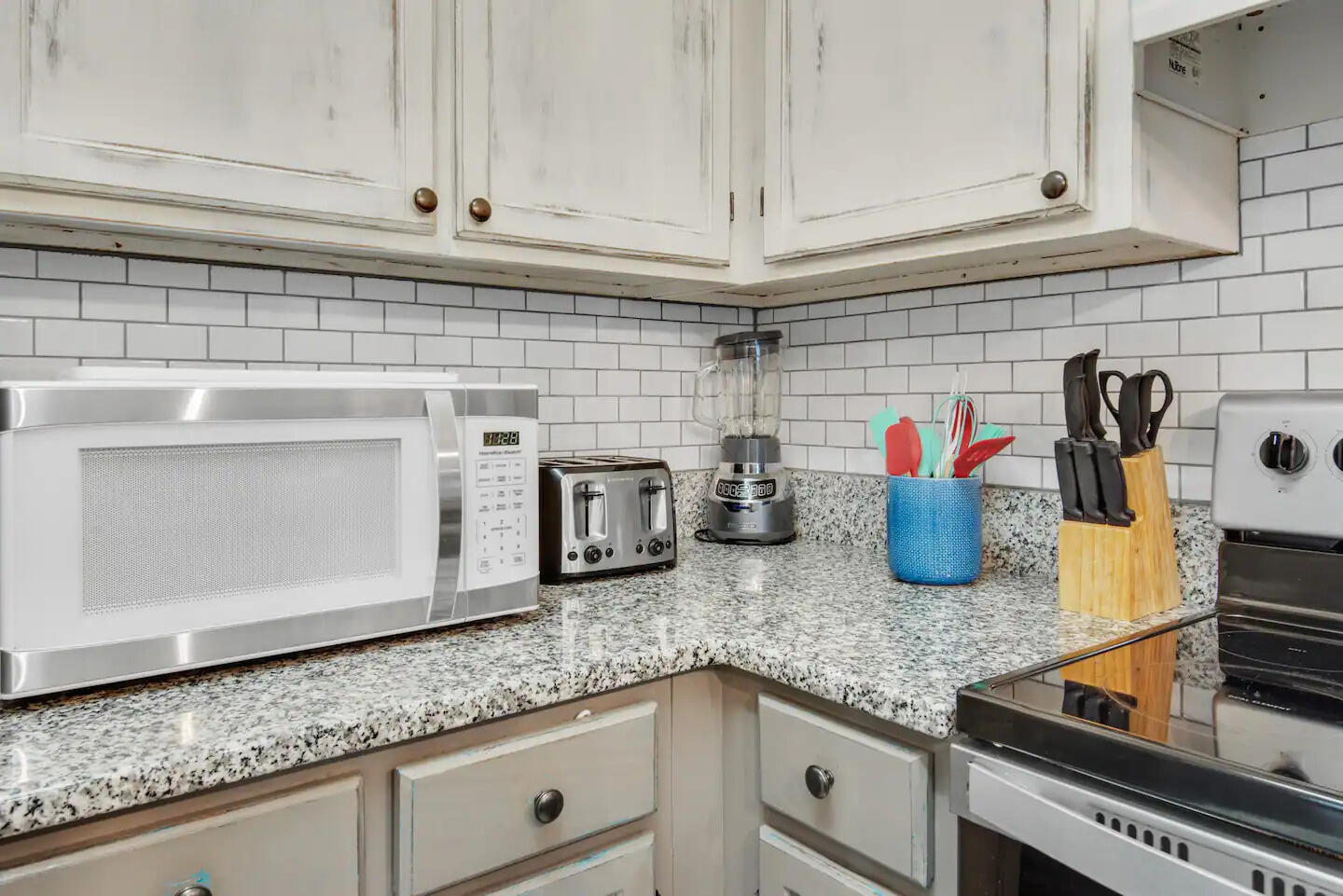 60 Sandprints Drive, Unit E3 Miramar Beach, FL 32550 - Photo 7 of 26 a kitchen with granite countertop white cabinets and sink