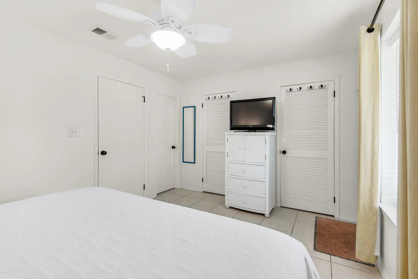 60 Sandprints Drive, Unit E3 Miramar Beach, FL 32550 - Photo 10 of 26 a bedroom with a bed and a flat tv screen on dresser