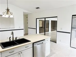 a kitchen with a sink and a refrigerator