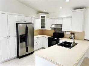 a kitchen with a refrigerator and a stove